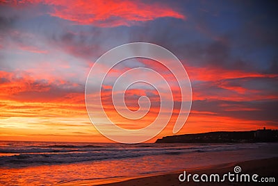 Red and orange sun rise over beach