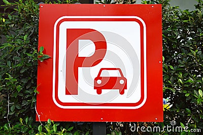 Red parking sign with green leaf
