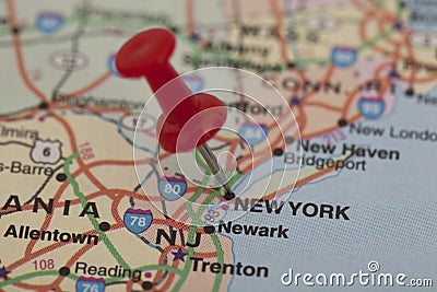 Red push pin pointing on new york