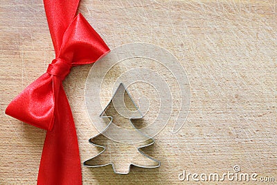 Red ribbon and bow on vintage cutting board christmas background