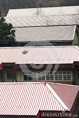 Red roof covered with snow