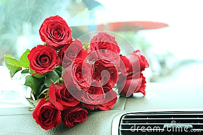 Red roses bouquet on car console