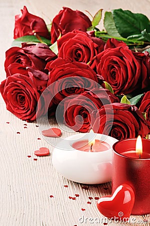 Red roses and candles in St Valentine s setting