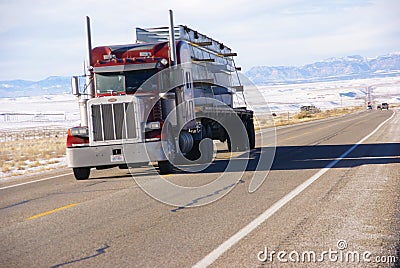 Red semi truck on winter road