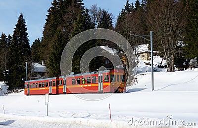 Red small train in Jura mountain