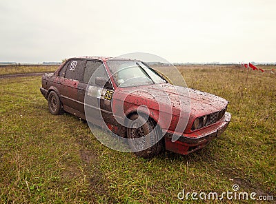 Red sport car on the mud