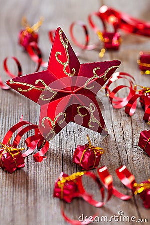 Red star , gifts and ribbons on wooden board