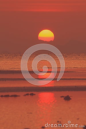 Red sunset over sea with golden light sky