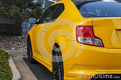 Red Taillight on Bright Yellow Car