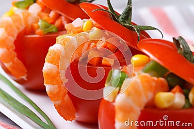 Red tomatoes stuffed with vegetables and shrimp. macro.