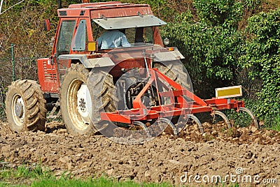 Red tractor at work