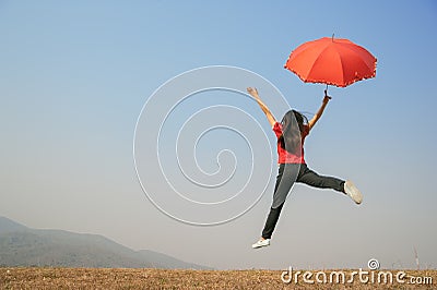 Red umbrella woman jump to Blue sky