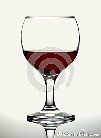 Red wine glass on graduated grey white background