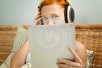 Red woman in bed listening to the music