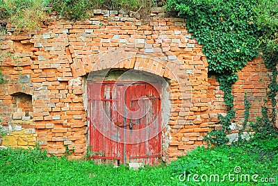 Red wooden door to an old wine cellar