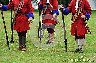 Redcoats with rifles standing to attention