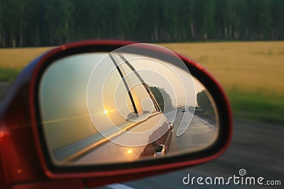 Reflection in mirror of moving car