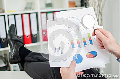 Relaxed businessman analysing a financial graph