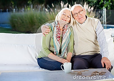 Relaxed Senior Man Sitting On Couch At Nursing