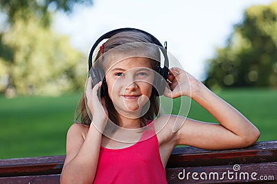 Relaxed Teenager girl listening music in park