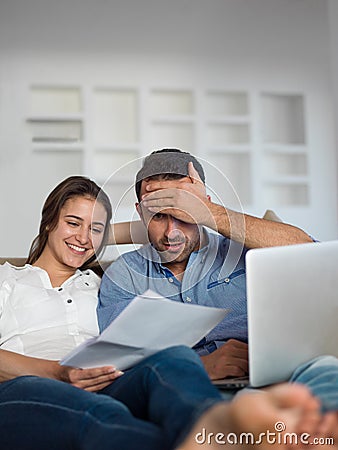 Relaxed young couple working on laptop computer at home