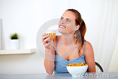 Relaxed young woman eating healthy breakfast