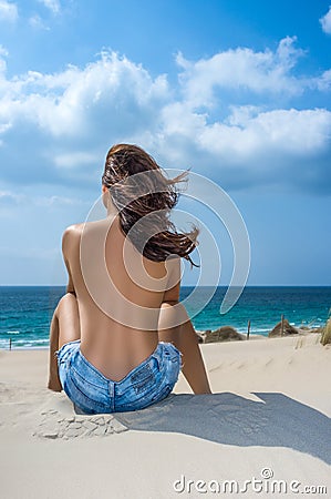 Relaxing. Young Girl Watching the Sea. Sunbathing