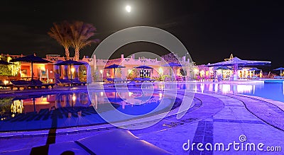 Resort hotel pool and patio at night