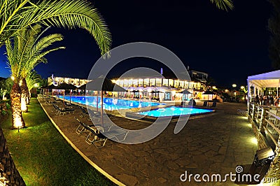 Resort pool area lit at night