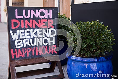 Restaurant sign on sidewalk