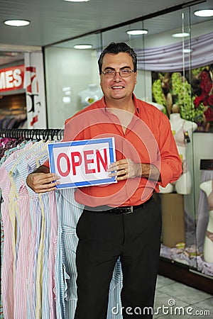 Retail business: store owner with open sign