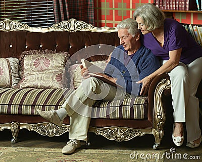 Retired couple reading book