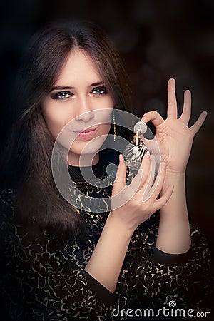 Retro glamour woman holding vintage perfume bottle