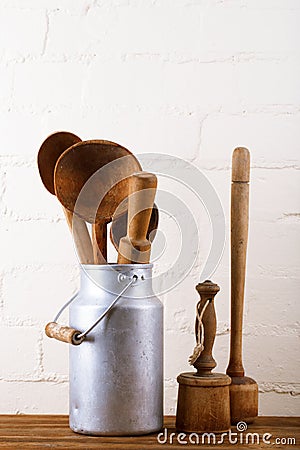 Retro kitchen utensils tools on old wooden table in rustic style