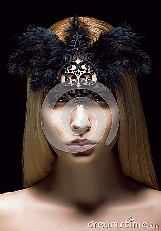 Beautiful Genuine Woman in Styled Black Mask with Feathers. Aristocratic Face