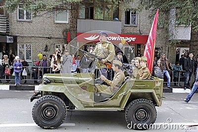 The retro military car with people in the form of fighters of th