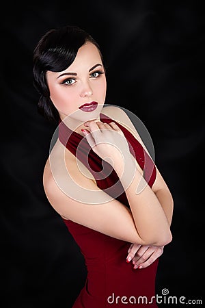 Retro style brunette woman touching her face