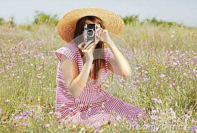 Retro style girl at countryside with camera