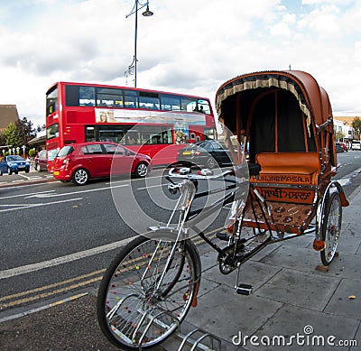 Rickshaw and a red double decker bus in London