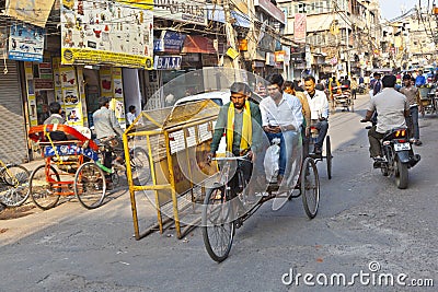 Rickshaw rider transports passenger