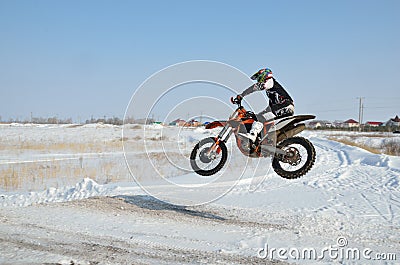 Rider on bike for motocross flies over hill