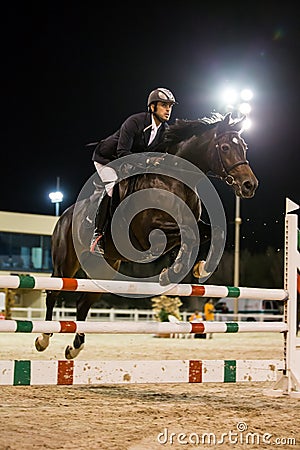 Rider competes in horse jumping competition