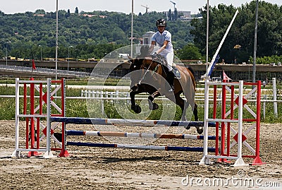 Rider and horse jump over barrier