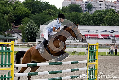 Rider jumping over the barrier-2