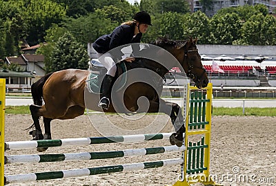 Rider jumping over the barrier-3