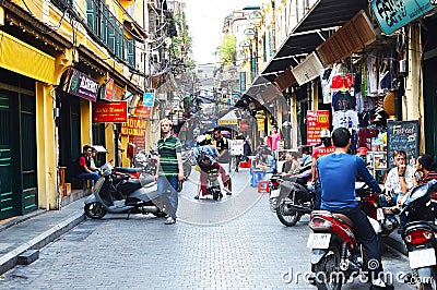 Riders ride motorbikes on busy road, Hanoi