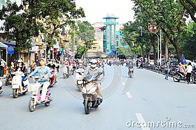 Riders ride motorbikes on busy road, Hanoi