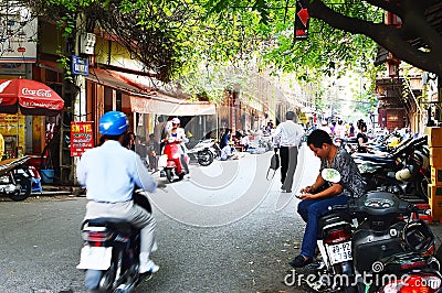 Riders ride motorbikes on busy road, Hanoi