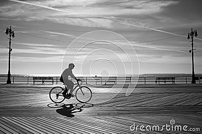 Riding a bicycle at the sunrise, Coney Island, New York