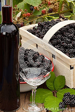 Ripe blackberries in bowl and fruit box